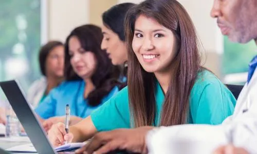 Practical Nurse at Laptop in School Taking On-Campus Nursing Classes