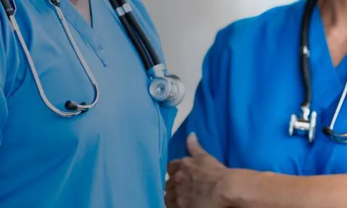 BSN Prepared Nurses in Blue Scrubs Discussing Patient Care