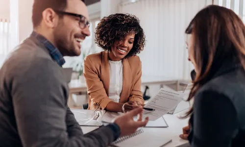 Accountants reviewing balance sheets in team meeting