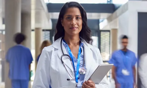 AG Acute Care Nurse Practitioner Holding Clipboard in Hospital
