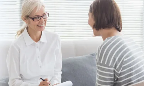 PMHNP Smiling with Patient in Appointment