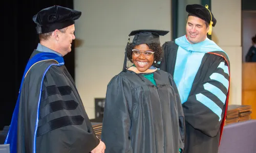 Herzing University graduate smiling at ceremony