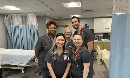 Group of online Herzing students gathered for in-person laboratory simulation