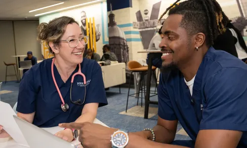 Tennessee nursing students in blue scrubs learning in simulation