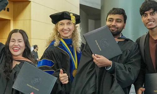 Herzing University international graduates celebrating together after the commencement ceremony.