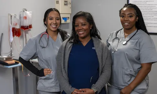 New Orleans nursing students in scrubs participating in on-campus simulation