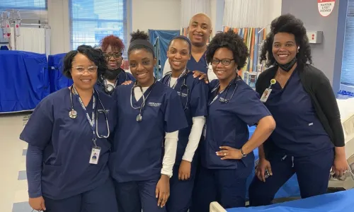 Group of Herzing University Atlanta nursing students posing together in the simulation lab.