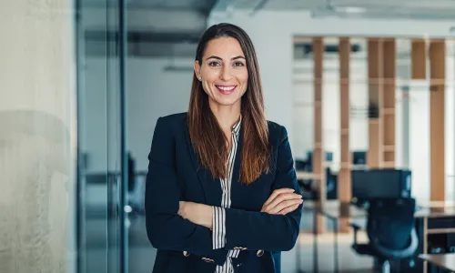 Herzing University online finance degree student representing leadership and career growth in a modern business setting.