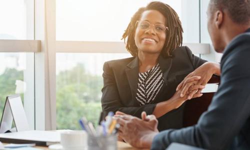 Human Resources Manager with HR MBA Smiling with Employee