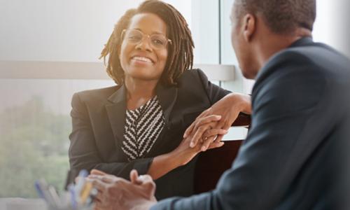 HR Manager with MBA Speaking with Employee 