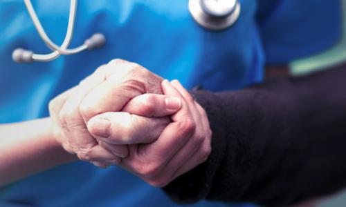 Psychiatric Mental Health Nurse Practitioner Holding Hands with Patient 