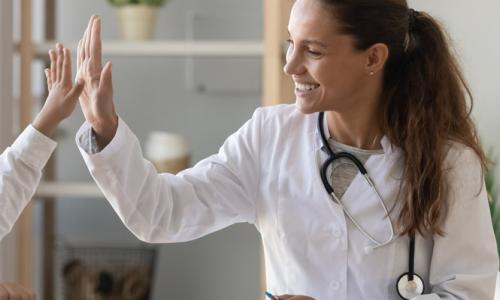 Family nurse practitioner high fiving pediatric patient