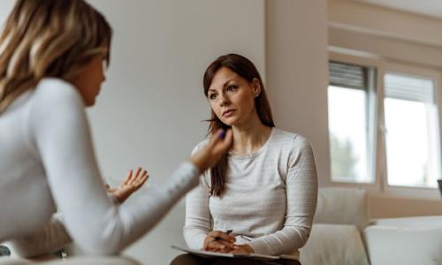 Psychiatric Mental Health Nurse Practitioner Consulting with Patient