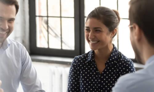 Human Services Worker with Associate Degree Smiling in Community Meeting