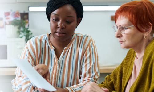 Social Worker LCSW Guiding Client Through Community Resource Documents