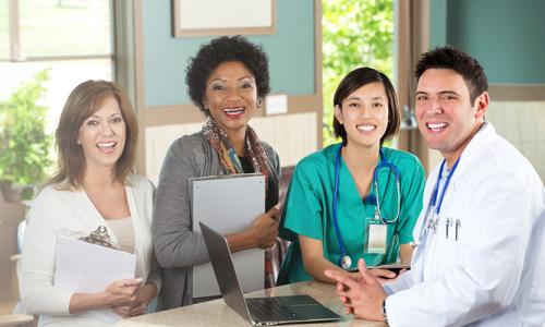 Public Health Nurse Smiling with Team of Healthcare Professionals