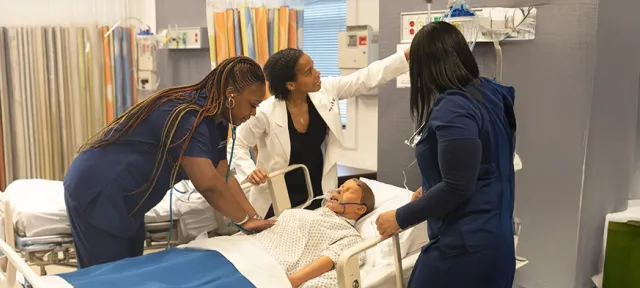 Herzing University nursing students engaging in a healthcare simulation environment.