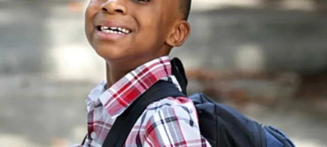 Child carrying new backpack