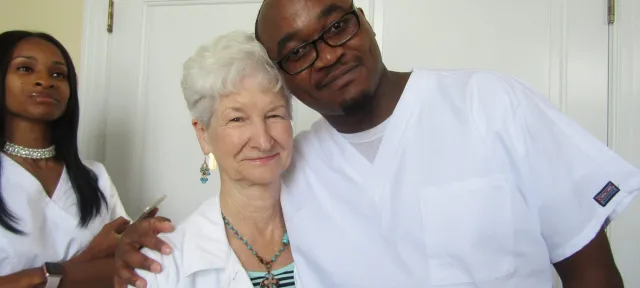 James Wanjiru smiling with patient Ms. Small