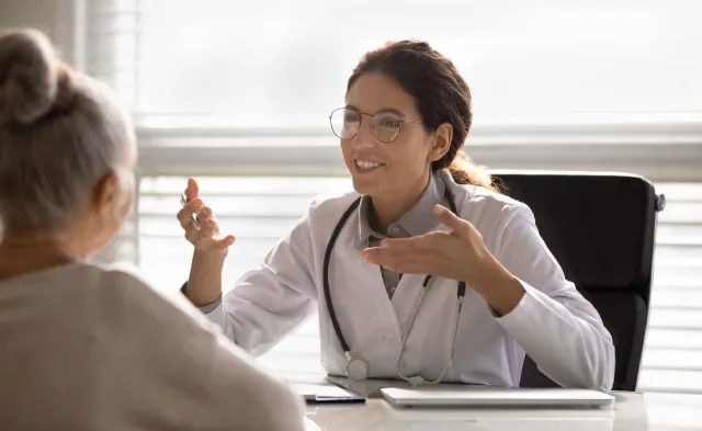 Nurse Practitioner Discussing Treatment Options with Adult Patient