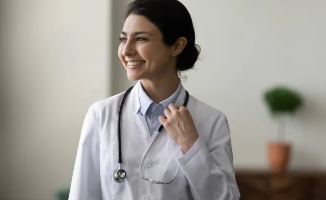 Family Nurse Practitioner in White Coat Smiling