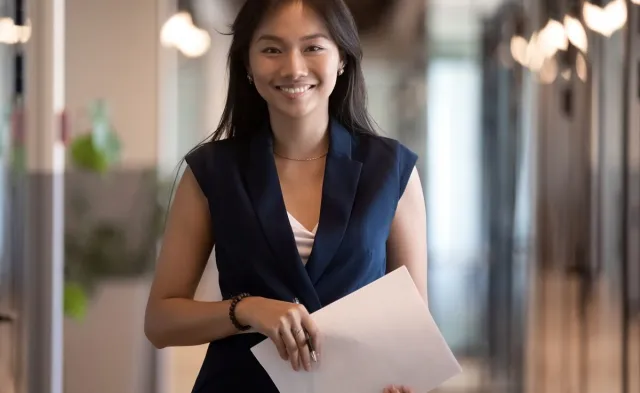 Human Resources HR Manager Smiling with Notes for Meeting