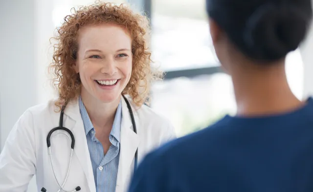 Public Health Nurse Smiling with Patient in Office