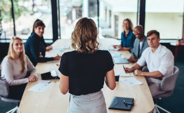 Marketing manager leading team meeting in office