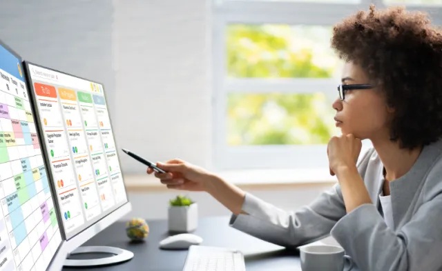 Project management team coordinating and update project planned schedule on computer