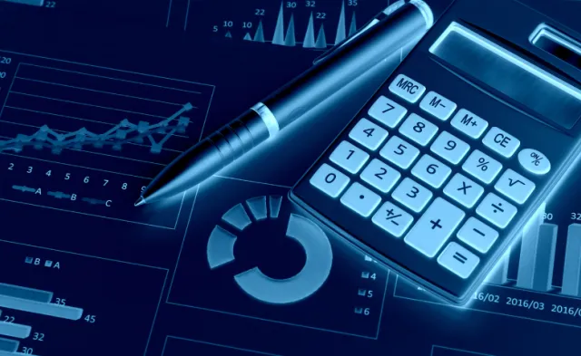 Calculator and financial documents on a desktop