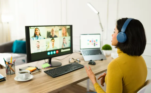 Young entrepreneur attending a virtual meeting with her team while working remotely from home