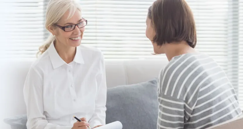 Psychiatric Mental Health Nurse Practitioner PMHNP Smiling with Adult Patient
