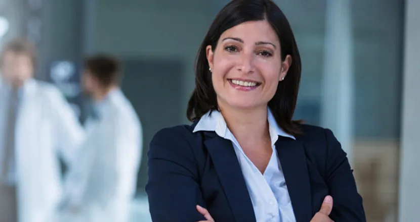 Nurse Leader with Healthcare Administrators in Meeting in Background