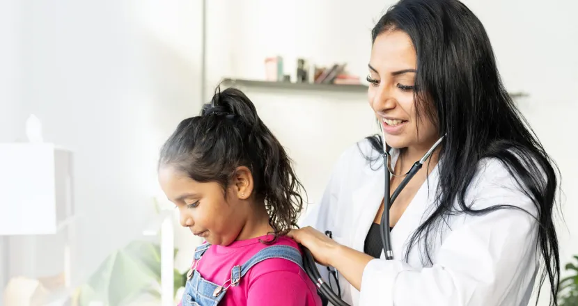 Pediatric nurse practitioner with DNP working with young patient
