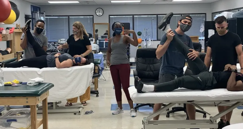Group of Herzing Orlando Physical Therapist Assistant students participating in class exercises