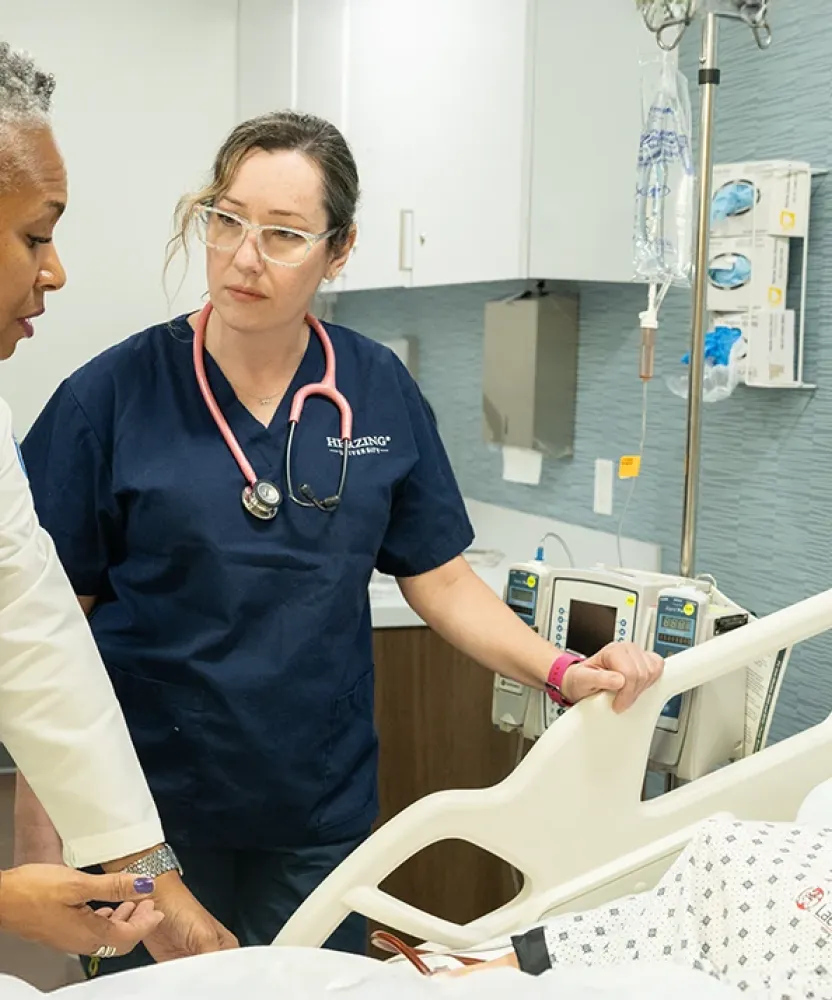 Accelerated BSN student in Atlanta with teacher in simulation lab