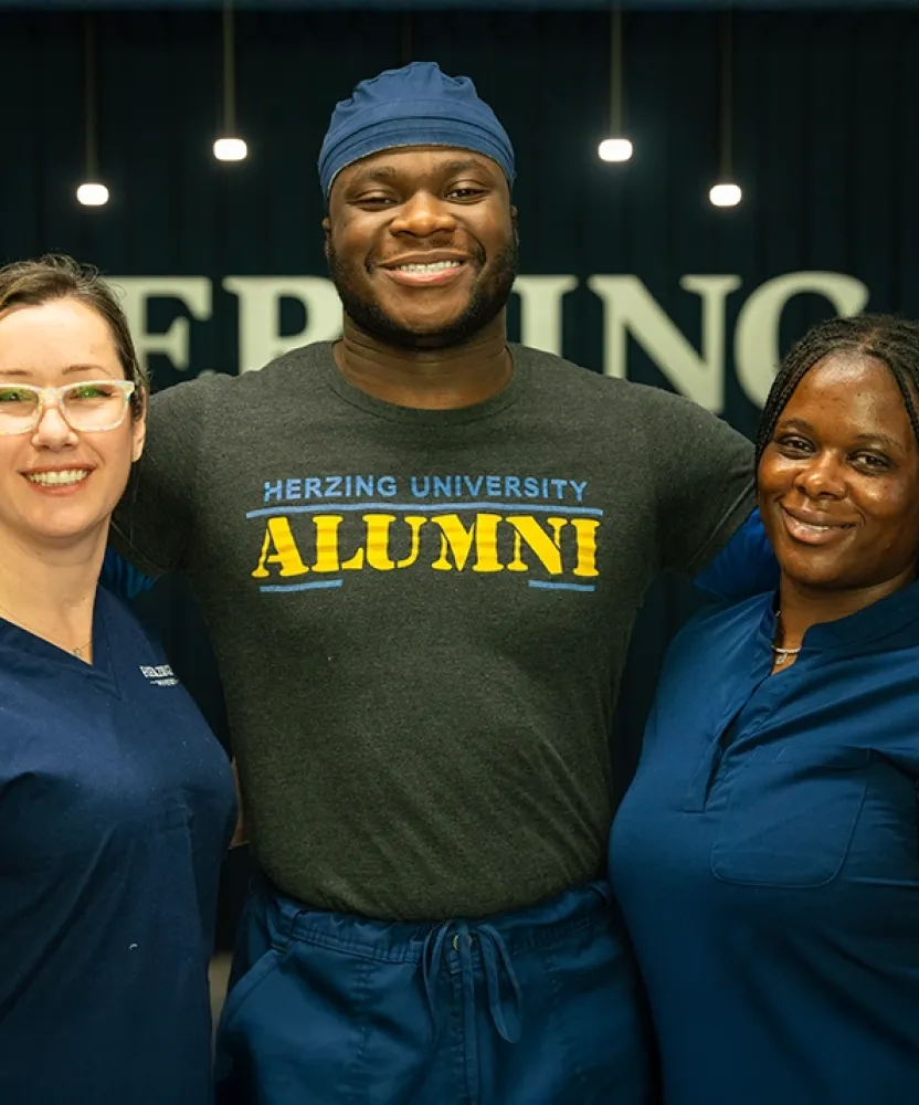 Herzing University Atlanta nursing alumni and students smiling together after clinical training.