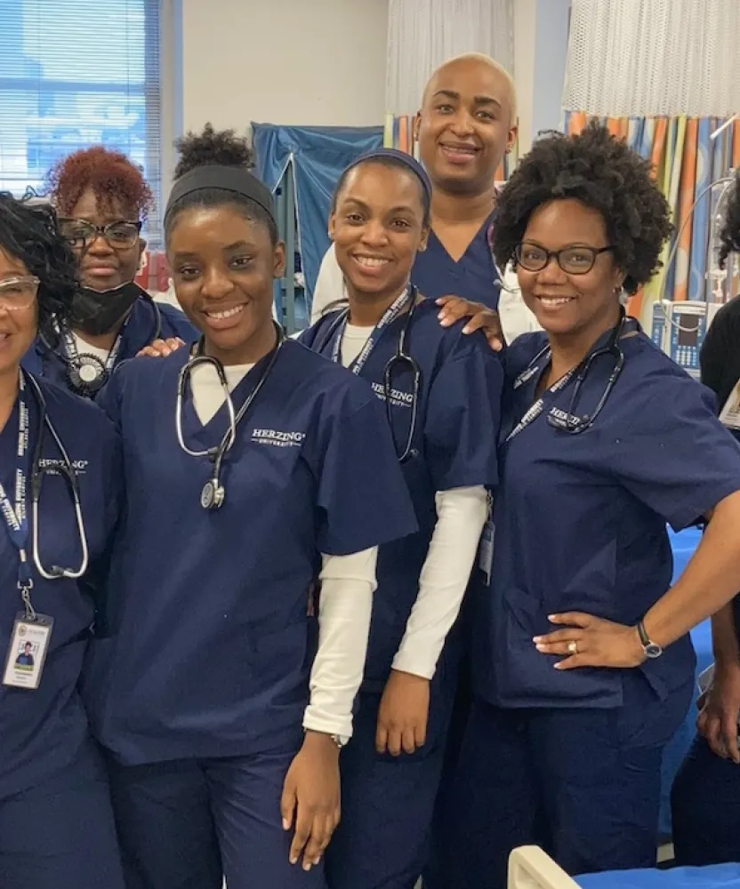 Group of Herzing University Atlanta nursing students posing together in the simulation lab.