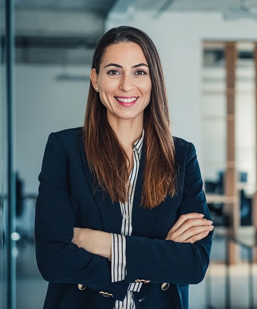 Herzing University online finance degree student representing leadership and career growth in a modern business setting.