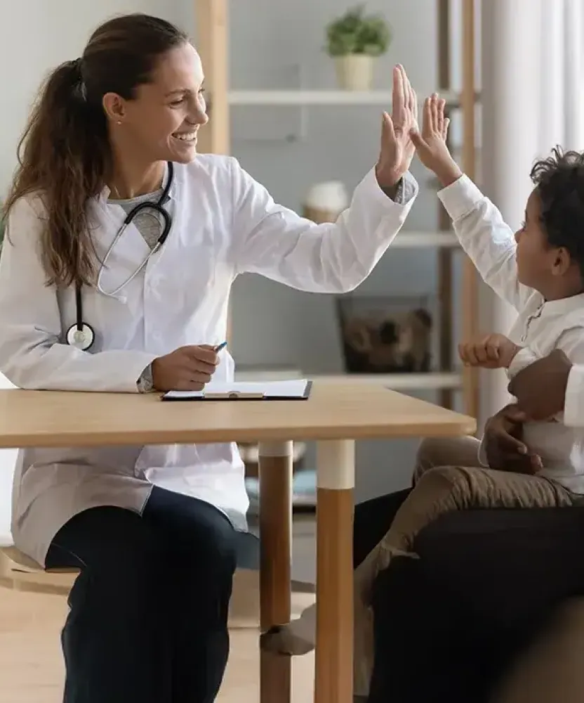 Family Nurse Practitioner FNP High Fiving Child Patient