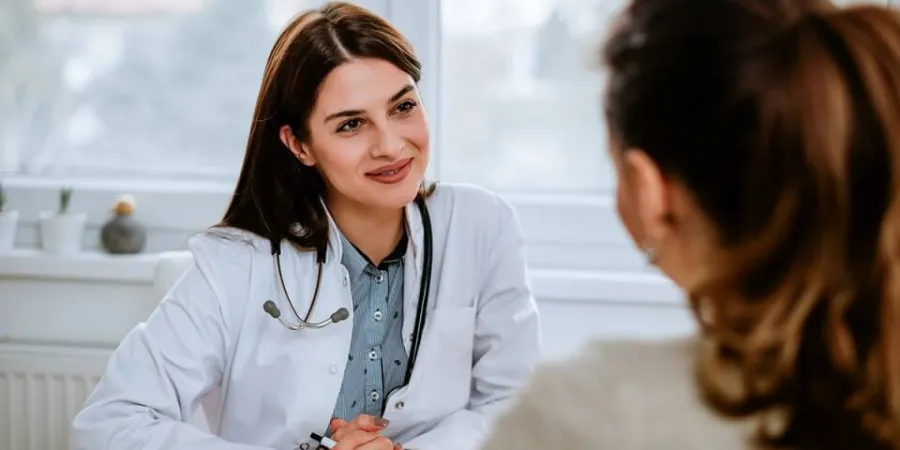 Family nurse practitioner smiling with patient during appointment