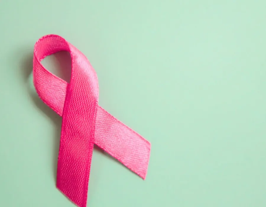 Pink ribbon pinned against green board