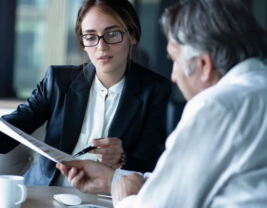 Accountant in meeting with client reviewing balance sheet