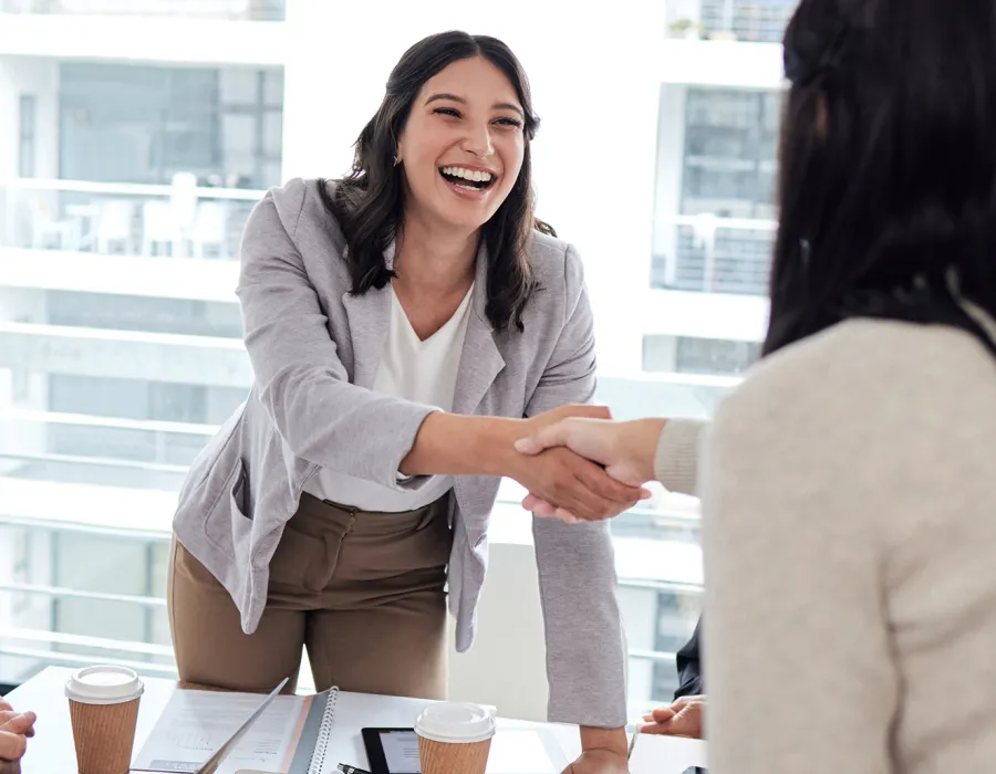 Human Resources Manager Smiling and Shaking Hands with Coworker