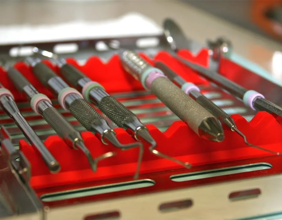 Tray of dental tools on a desk beside patient dental chair