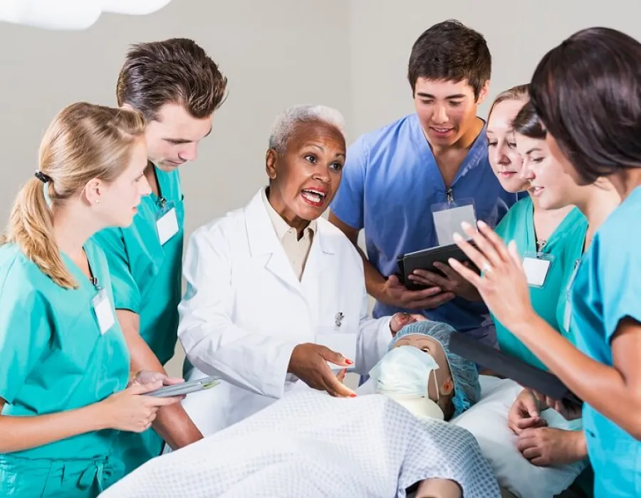 Nurse educator leading class discussion in laboratory experience