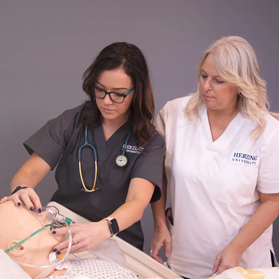 Accelerated Nursing Student Under Instruction in Laboratory Experience