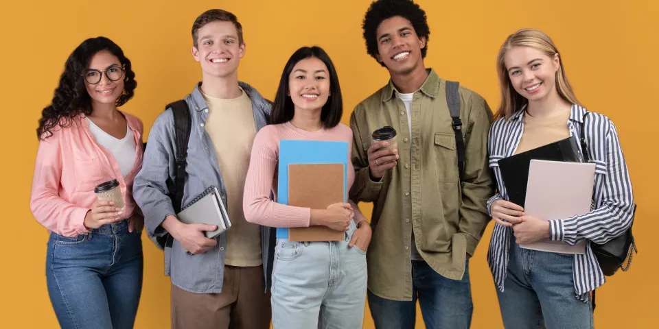 Five college students holding notebooks and folders