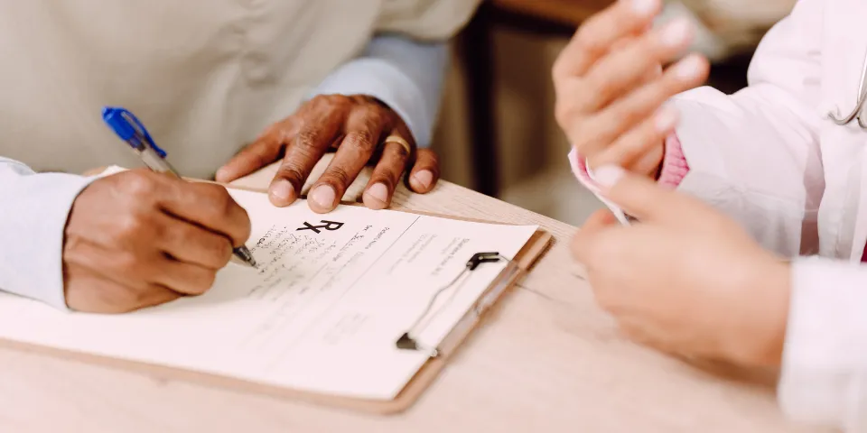 Nurse Writing Prescription with Nurse Educator's Guidance