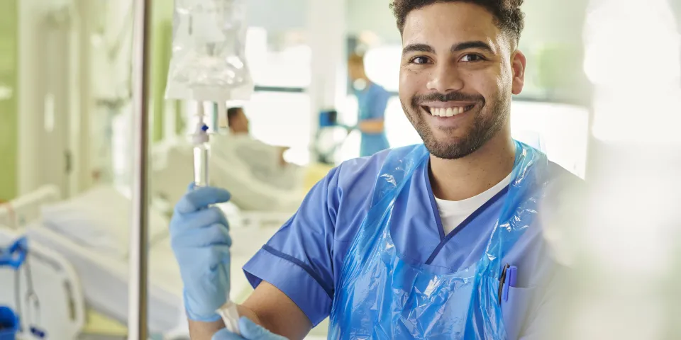 young male nurse adjusting iv drip